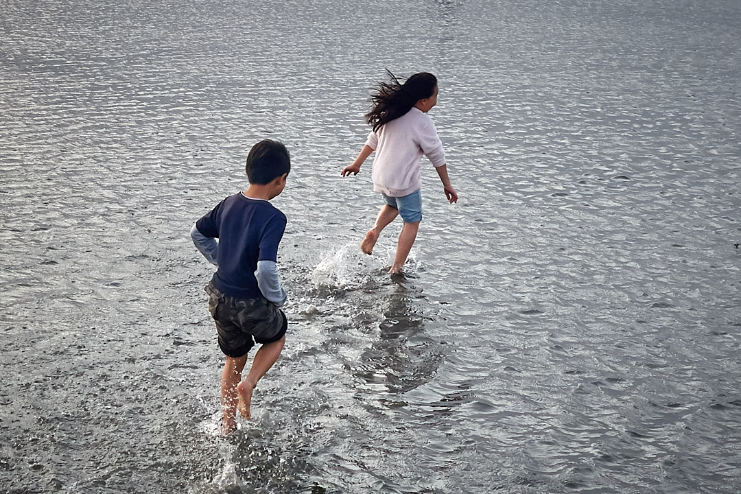 Children running in water